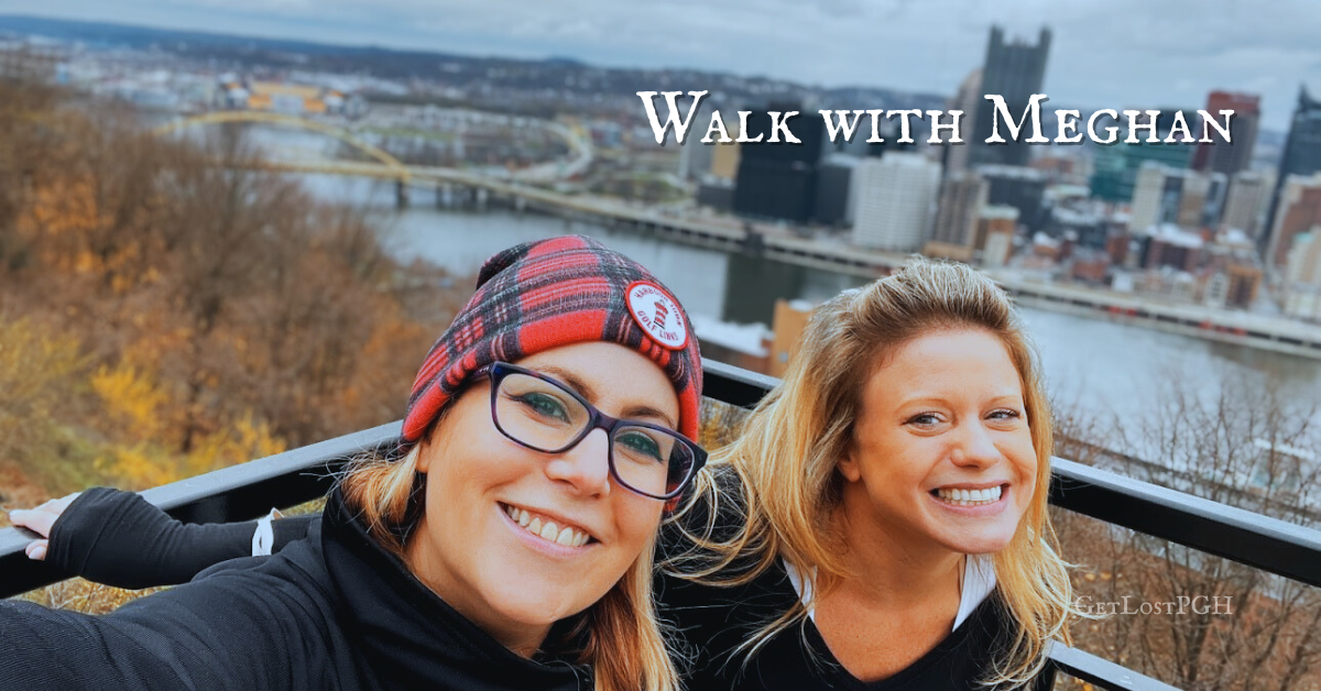 Meghan Snatchko and a smiling friend overlooking the Pittsburgh skyline and rivers on a crisp autumn day, promoting Walk With Meghan private walking tours by GetLostPGH.